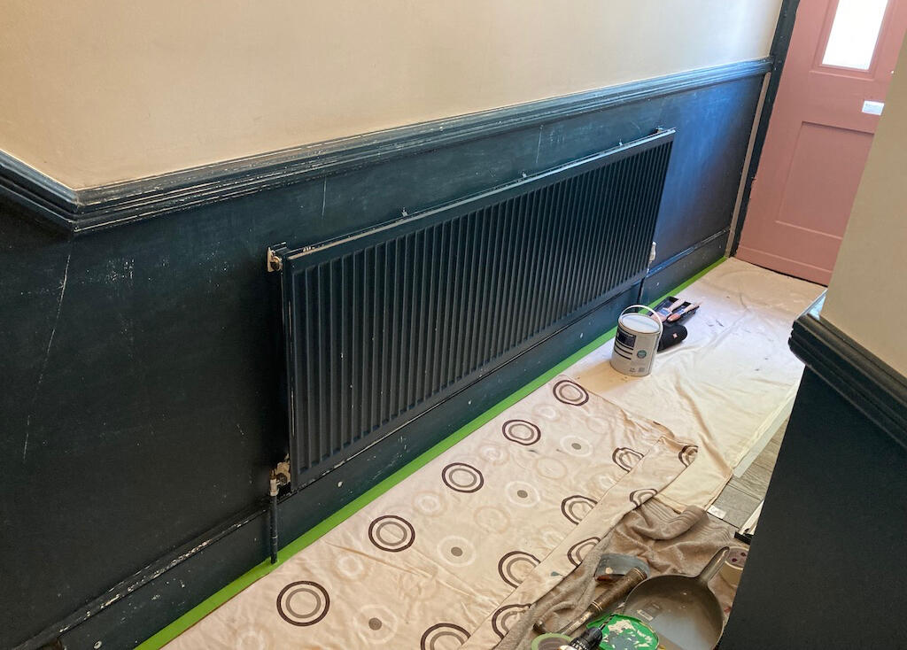 Landing walls before painting, showing old paint and preparation work needed